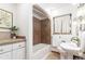 Charming bathroom featuring neutral tiling, an updated shower and vanity, and lots of natural light at 2745 N Saint Paul St, Denver, CO 80205