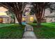 Charming brick home framed by mature trees, with a welcoming walkway leading to the entrance at 2745 N Saint Paul St, Denver, CO 80205