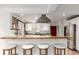 Modern kitchen featuring a breakfast bar, white cabinets, stainless steel appliances, and stylish decor at 2745 N Saint Paul St, Denver, CO 80205
