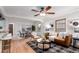 Spacious living room with hardwood floors, comfortable seating, and a seamless flow to the dining area at 2745 N Saint Paul St, Denver, CO 80205
