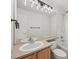 Bathroom with shower-tub, light wood vanity, and contemporary light fixture at 10235 Rustic Redwood Ln, Highlands Ranch, CO 80126