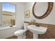 Charming powder room with pedestal sink and decorative accents at 10235 Rustic Redwood Ln, Highlands Ranch, CO 80126