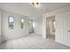 Neutral bedroom featuring three windows and an adjacent doorway at 10235 Rustic Redwood Ln, Highlands Ranch, CO 80126