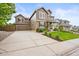 View of the exterior with a large driveway and a two-car garage attached to the right of the house at 10235 Rustic Redwood Ln, Highlands Ranch, CO 80126