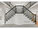An expansive foyer with a staircase, dark railings, and a view of the home's layout at 10235 Rustic Redwood Ln, Highlands Ranch, CO 80126