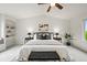 Beautiful primary bedroom featuring a ceiling fan, neutral decor, and a large window for natural light at 10235 Rustic Redwood Ln, Highlands Ranch, CO 80126