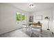 Bright home office with a wooden desk, two chairs, and a large window with natural light at 10235 Rustic Redwood Ln, Highlands Ranch, CO 80126