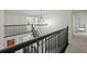 Elegant staircase with modern railing, open floor plan, and bright natural light at 10235 Rustic Redwood Ln, Highlands Ranch, CO 80126