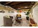 Basement with exposed ceiling, painted brick, comfortable seating, and stylish decor at 325 E 7Th Ave, Denver, CO 80203