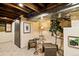 Nicely finished basement space with exposed ceiling, painted brick, and comfortable seating at 325 E 7Th Ave, Denver, CO 80203