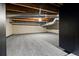 Unfinished area of the basement space with carpet flooring and painted brick at 325 E 7Th Ave, Denver, CO 80203