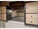 View of a bonus storage space in the basement with carpet flooring and painted brick at 325 E 7Th Ave, Denver, CO 80203