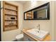 Bathroom with a modern vanity, stylish mirror, and a built-in shelving niche at 325 E 7Th Ave, Denver, CO 80203
