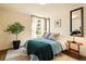 Well-lit bedroom with a large window, stylish decor, and comfortable furnishings at 325 E 7Th Ave, Denver, CO 80203