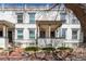Charming two-story white brick home featuring a covered front porch and well-maintained landscaping at 325 E 7Th Ave, Denver, CO 80203