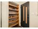 Hallway with built-in shelving and stylish front door featuring vertical wood panels at 325 E 7Th Ave, Denver, CO 80203