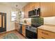 Modern kitchen featuring stainless steel appliances, updated cabinets, and stylish backsplash at 325 E 7Th Ave, Denver, CO 80203