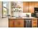 Bright kitchen with ample counter space, stainless steel appliances, and wooden shelving at 325 E 7Th Ave, Denver, CO 80203