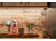 Close-up of brick backsplash with wooden countertop detail in updated kitchen at 325 E 7Th Ave, Denver, CO 80203