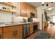 Well-lit kitchen featuring modern appliances, open shelving, and stainless steel sink at 325 E 7Th Ave, Denver, CO 80203