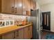 Kitchen with brick wall detail, stainless steel refrigerator, and wooden countertops at 325 E 7Th Ave, Denver, CO 80203