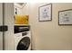 Convenient laundry area with a modern washer and dryer and space-saving shelving at 325 E 7Th Ave, Denver, CO 80203