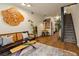 Open-concept living room with stylish decor, a comfortable sofa, and staircase at 325 E 7Th Ave, Denver, CO 80203