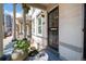 Charming front porch featuring an iron gate, a small table, and decorative plants at 325 E 7Th Ave, Denver, CO 80203