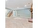 Finished basement with brick fireplace, carpet, and stairs at 6143 E Hinsdale Ave, Centennial, CO 80112