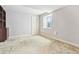 Basement features a window for natural light, carpeted floors, and a storage area at 6143 E Hinsdale Ave, Centennial, CO 80112