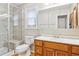 Bathroom featuring tiled shower, neutral vanity and modern fixtures at 6143 E Hinsdale Ave, Centennial, CO 80112