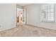 Bedroom featuring neutral carpet, a window with blinds, and a doorway looking to hall at 6143 E Hinsdale Ave, Centennial, CO 80112