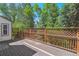 Wooden deck surrounded by trees offers serene outdoor living and entertaining space at 6143 E Hinsdale Ave, Centennial, CO 80112