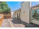 Spacious wooden deck features backyard access and exterior lighting for evening enjoyment at 6143 E Hinsdale Ave, Centennial, CO 80112
