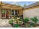 Charming garden space at the front entrance features brick accents and a covered porch at 6143 E Hinsdale Ave, Centennial, CO 80112