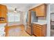Kitchen features stainless steel refrigerator, wood cabinets, and eat-in area at 6143 E Hinsdale Ave, Centennial, CO 80112