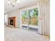 Inviting living room with a brick fireplace and sliding glass doors leading to the outdoor deck at 6143 E Hinsdale Ave, Centennial, CO 80112