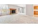 Spacious living room with fireplace, access to the outdoor deck, and adjoining kitchen at 6143 E Hinsdale Ave, Centennial, CO 80112