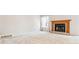 Cozy living room featuring a classic brick fireplace and neutral carpeting at 6143 E Hinsdale Ave, Centennial, CO 80112