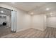 Open basement space with modern recessed lighting and hardwood style flooring at 22870 E Chenango Ave, Aurora, CO 80015