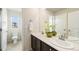 Bathroom featuring double sinks, a large mirror, and a bright window for an airy, refreshing feel at 22870 E Chenango Ave, Aurora, CO 80015