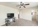 Spacious bedroom with neutral carpet, a ceiling fan, and a designated area for television or desk at 22870 E Chenango Ave, Aurora, CO 80015
