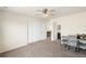 Bright bedroom featuring neutral tones, a ceiling fan, closet, and doorway leading to an en-suite bathroom at 22870 E Chenango Ave, Aurora, CO 80015