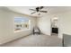 Bedroom with natural light, neutral walls, and carpet, plus convenient access to a full bathroom at 22870 E Chenango Ave, Aurora, CO 80015