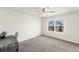 Bright bedroom with neutral carpet, natural light from a window, and a versatile workspace at 22870 E Chenango Ave, Aurora, CO 80015