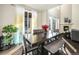 Bright dining room with a large dark wood table, ample natural light, and a view of the backyard at 22870 E Chenango Ave, Aurora, CO 80015