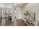 Inviting entryway with dark wood flooring, a decorative console table, and a view into the adjacent living space at 22870 E Chenango Ave, Aurora, CO 80015
