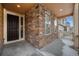 Inviting front porch with stone accents, providing a cozy entry to the home and an outdoor sitting area at 22870 E Chenango Ave, Aurora, CO 80015