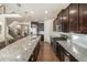 Bright and airy kitchen featuring granite counters, stainless appliances, with hardwood floors and access to the stairway at 22870 E Chenango Ave, Aurora, CO 80015