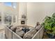 Bright living room with a cozy fireplace, high ceilings, and a large sectional sofa at 22870 E Chenango Ave, Aurora, CO 80015